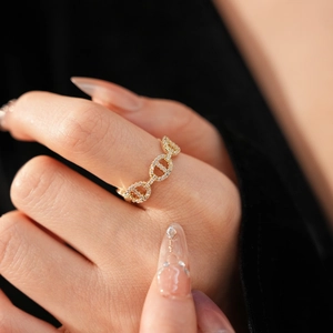 Macro shot of gold-plated pig nose ring with pavé zircons showing luxury texture