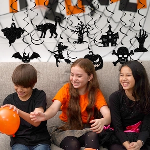Black glittery Halloween hanging decorations set with ghost pumpkin bats over playing kids