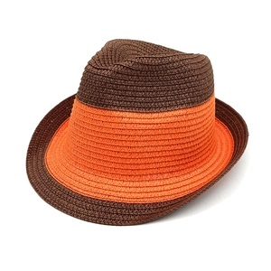 Close-up of contrast weave texture on a two-tone brown and orange straw fedora hat
