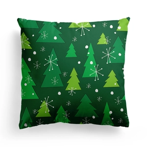 Green Christmas pillow cover with festive tree and snowflake patterns on white background