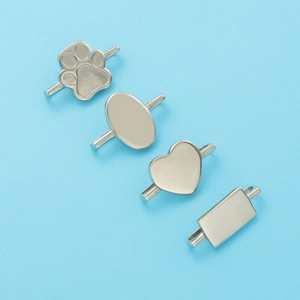 Detail of silver stainless steel watch band charms in paw, heart and oval shapes