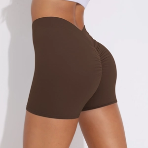Detail view of high waist scrunch butt yoga shorts in dark brown with compression fabric