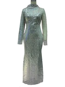 Close-up of shimmering silver sequins on a long-sleeved fishtail evening gown fabric
