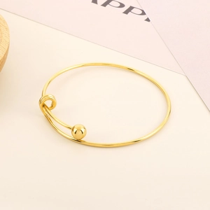 Minimalist gold steel bead open bangle with a smooth finish and sleek wrap design
