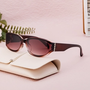 Chic burgundy polarized sunglasses with gradient lenses on an off-white leather case