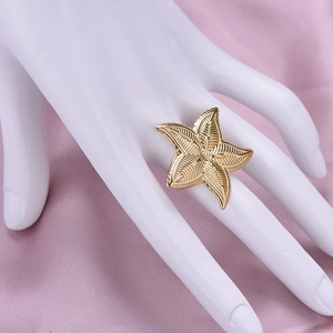Golden starfish ring in 304 stainless steel on white hand model and pink silk fabric