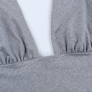 Macro view of grey knitted top with square neck design and precise pleated stitching detail