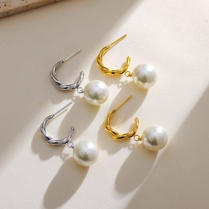 Elegant gold and silver twist metal earrings with round white hanging pearls