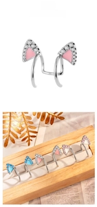 Detailed view of cat-ear cuffs with micro-set zircons and colorful enamel inlay