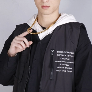 Detail of 7mm gold-plated stainless steel box chain necklace worn by a male model