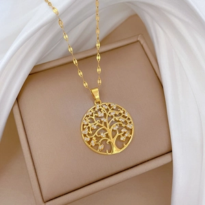 Macro shot of gold tree of life necklace pendant with crystals on satin fabric