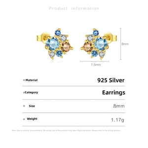 Macro detail of 925 sterling silver stud earrings with multi-color cubic zirconia stones