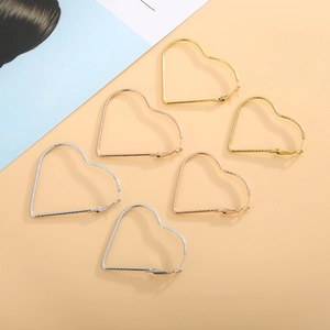 Textured heart-shaped hoop earrings in gold, silver, and rose gold plating