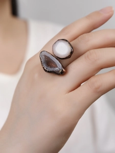 Detail of adjustable brass ring with natural white and brown agate slices on hand