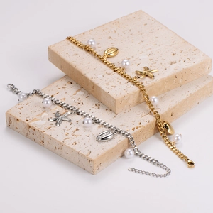 Luxe stainless steel charm bracelets with starfish, shell and pearl accents in gold and silver