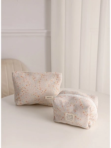 Set of beige woven tweed makeup bags with colorful specks and zipper closure
