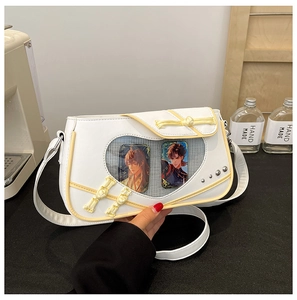 Close-up of heart-shaped window on white ita bag with Chinese knot and yellow piping