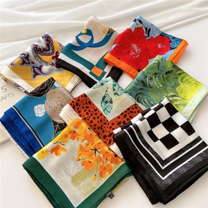 Collection of assorted printed silk scarves featuring paisley and geometric patterns