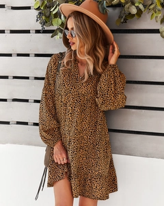 Macro detail of casual loose leopard print dress with mid-length sleeves and rustic background