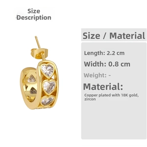 Detailed view of 18K gold plated copper C-shape earrings with heart-cut cubic zirconia