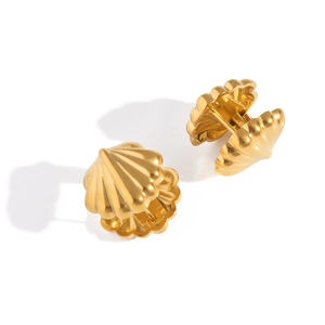 Macro shot of gold shell hoop earrings featuring vertical textured stripes on white background