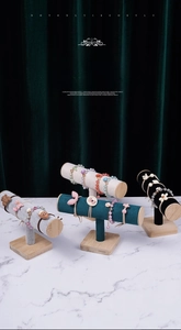 Detail view of T-bar display stands featuring colorful beaded bracelets and hair accessories