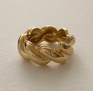 Close-up of golden S925 sterling silver braided ring showcasing textured metal detail