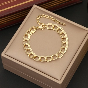 Detail of gold-plated stainless steel oval link bracelet with lobster clasp and extender