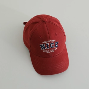 Close-up of NICE letter embroidery on deep red cotton baseball cap for kids