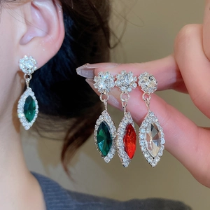 Detailed close-up of crystal flower teardrop earrings in green, red, and white gems