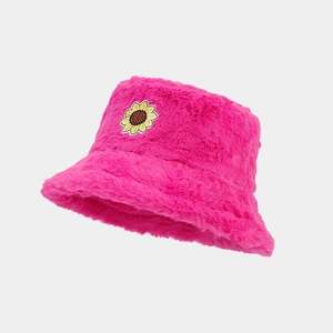 Close-up of rose pink faux fur bucket hat featuring a detailed sunflower embroidery patch