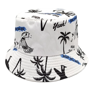 Detail of white bucket hat featuring black palm trees and Ride the Wave ocean prints