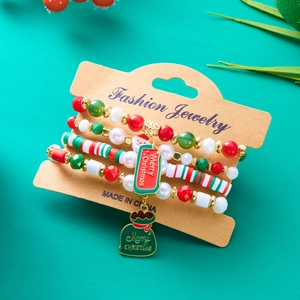 Detail of Christmas beaded bracelet set featuring Santa Claus pendants and festive charms