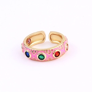 Detailed macro view of pink enamel gold ring with colorful micro-set zircons