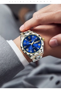 Men's business quartz watch with blue sunray dial and gold-silver steel band worn on wrist