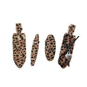 Set of four vintage leopard print hair clips featuring bow and heart charm accents