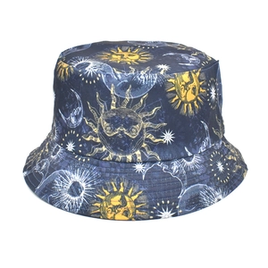 Detail of navy blue bucket hat featuring yellow sun, moon and star prints with stitching