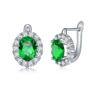 Close-up of halo stud earrings with oval green zircon and white crystal accents