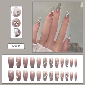 Detail of luxury press-on nails featuring grey-purple gradient with silver butterfly and pearls
