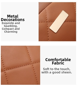 Detail der braun gesteppten Ledertextur und polierter Goldbeschläge eines Freizeitrucksacks
