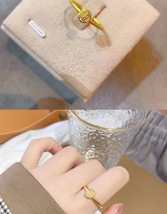 Macro view of gold bow ring with wheat ear motif and 18K gold plating finish