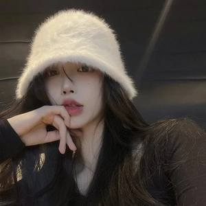 Close-up of plush white bucket hat with soft faux fur texture for winter warmth