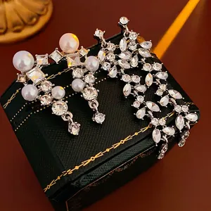 Silver leaf earrings with long tassels, faux pearls and sparkling cubic zirconia stones
