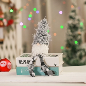 Close-up of sitting Christmas gnome with plush grey beard and black-white checkered hat