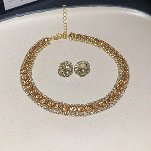 Detail of gold necklace and earring set with amber stones and adjustable lobster clasp