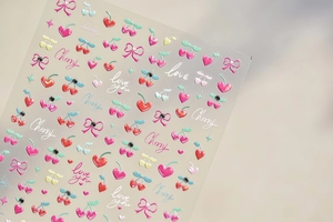 Detail of crystal nail stickers with cherry, heart, and glitter bow designs