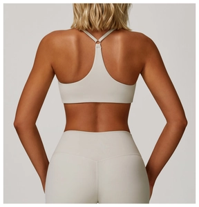 Close-up of racerback sports bra with adjustable strap ring and high waist yoga leggings