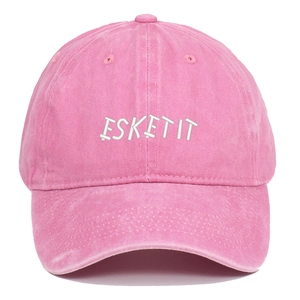 Close-up of pink washed cotton baseball cap with white ESKETIT letter embroidery detail