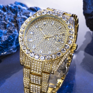 Macro shot of gold hip hop watch dial encrusted with diamonds and date display