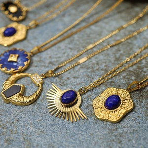 Detailed close-up of 18K gold plated vintage flower pendants with lapis lazuli stones